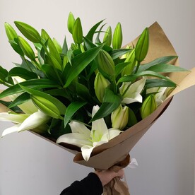 7 белых лилий в крафтовой упаковке