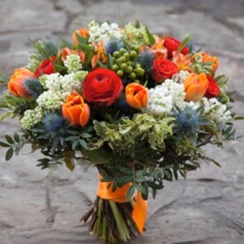 Роза кустовая оранжевая, Ранункулюс красный, Тюльпан оранжевый, Альстромерия оранжевая, Гиперикум зелёный, Сирень белая, Эрингиум, Питоспорум, Писташ, оранжевая