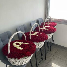 Ваше имя из белых роз на фоне красных роз в больших корзинах