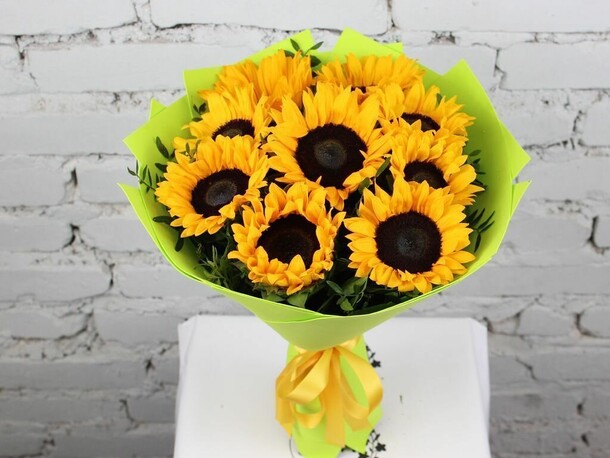Букет 9 подсолнухов с зеленью в упаковке, артикул F1151310 - 4790 рублей, доставка по городу. Flawery - доставка цветов